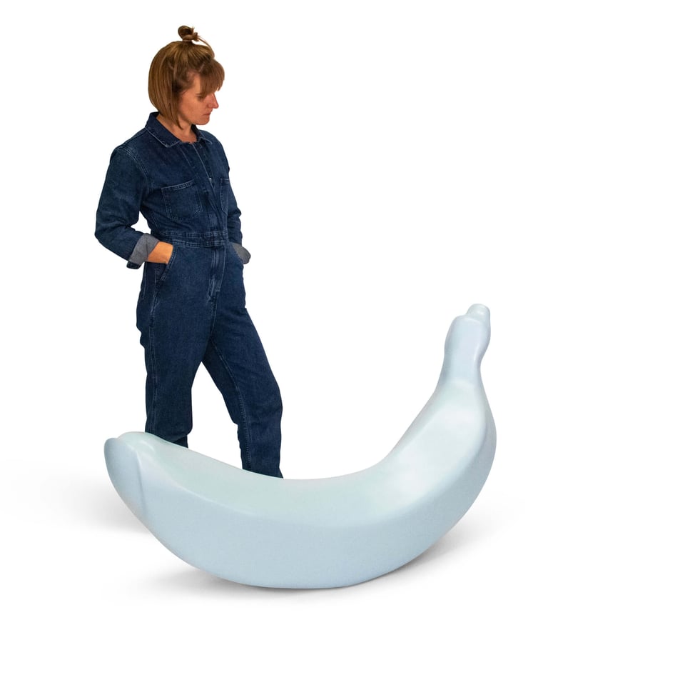 Gracelee stands next to a large finger-banana sculpture