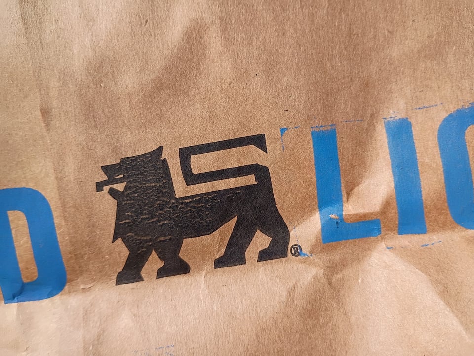 A close up detail of the Food Lion logo printed on a paper bag