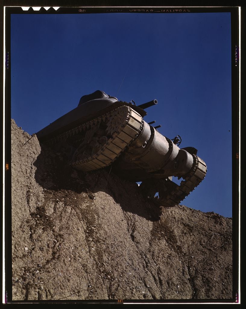 a tank teeters on the edge of a cliff