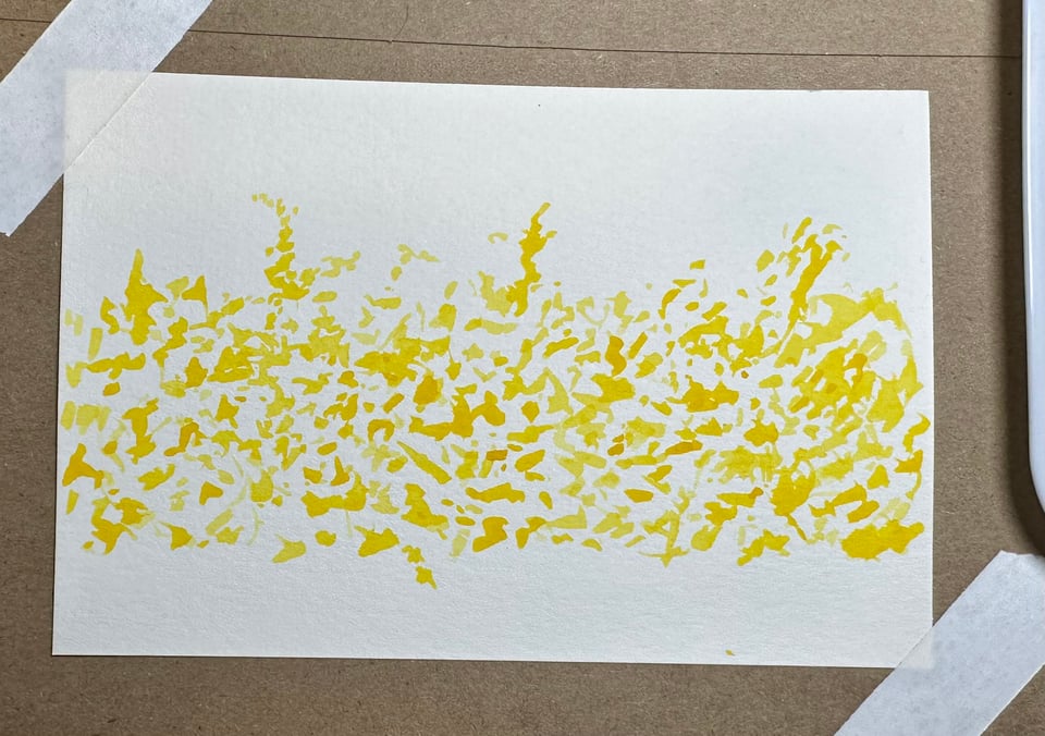 photo of a postcard with yellow/gold splotches meant to signify flowering forsythia