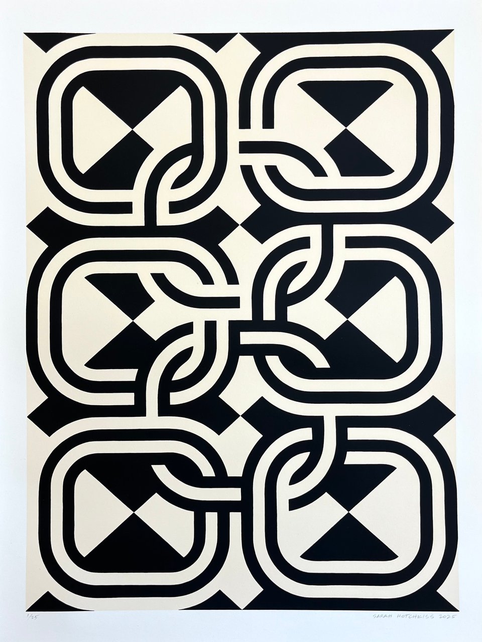 black and ivory graphic print of 8 linking circles against diamond checkered background