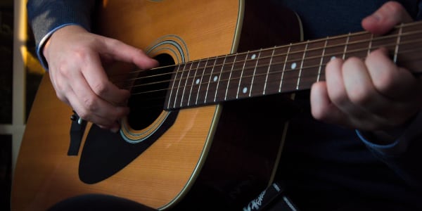 An acoustic guitar being played
