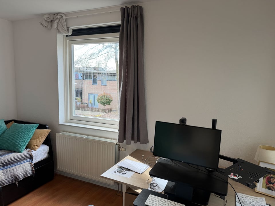 An home office with a fixed window.