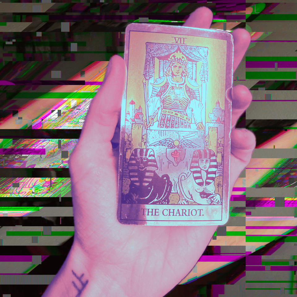 A purple hand holding the Chariot card in front of a glitchy background.