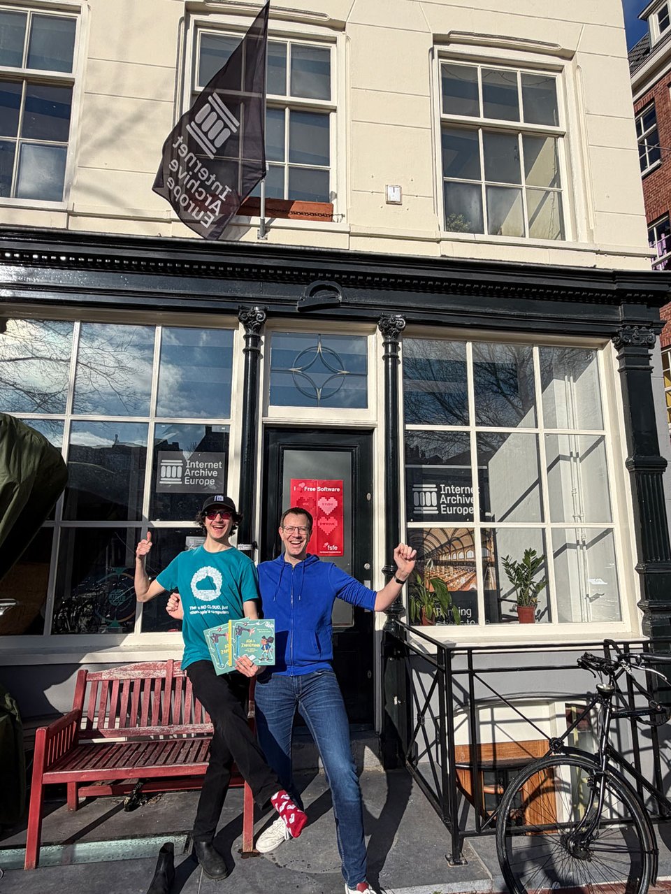 Two men stand in front of the Internet Archive Europe Headquarters in Amsterdam.