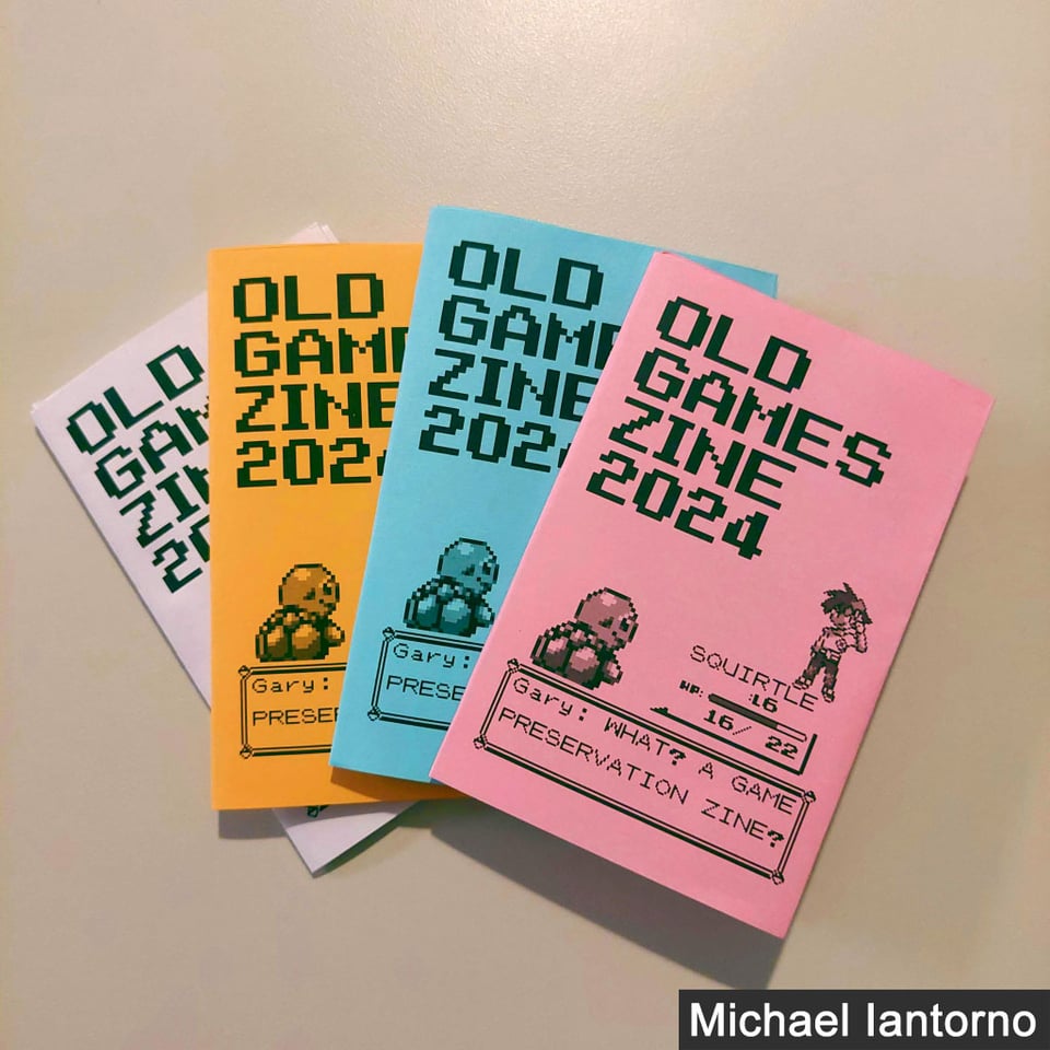 Four copies of Old Games Zine 2024 with purple, orange, blue, and pink covers