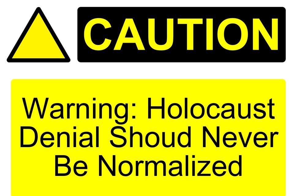 A warning sign saying that Holocaust Denial Should Never Be Normalized.
