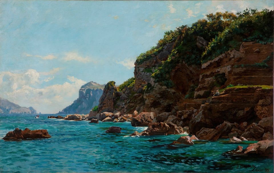 a view of a turquoise sea and cliffs