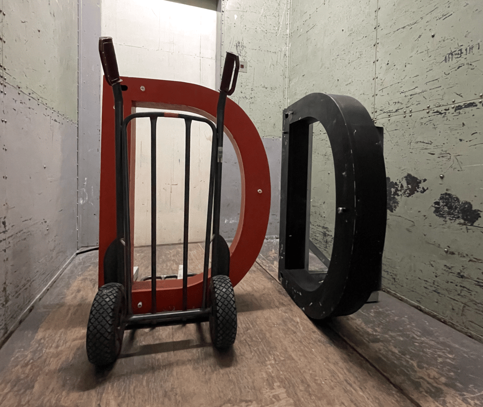 Two capital letters D in a freight elevator.