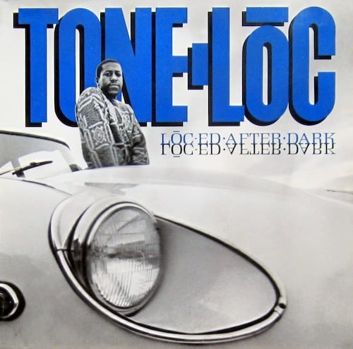 A black and white photo of Tone Lōc, a Black man in a patterned sweater. He's standing at the driver's side door of a car. He looks vaguely sad or perhaps bored. The shot is taken low from the opposite side of the car, so the car dominates the picture. The headlight of the car, very large in the picture, is recessed into the body of the car in a way I've never seen before. Wikipedia says it's a Jaguar e-type car, and the cover is based on jazz legend Donald Byrd's cover for A NEW PERSPECTIVE. I just looked at that cover, and yes, it is.