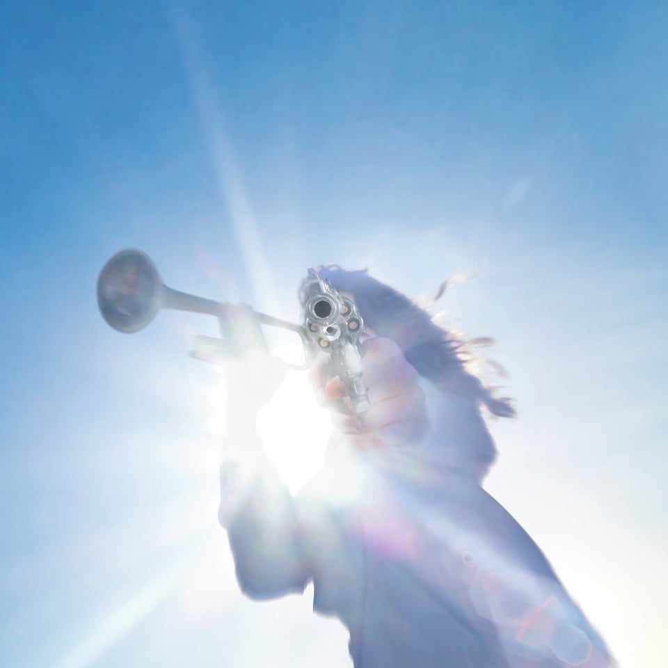 someone stands in the path of the sun in a crystal blue sky, playing a trumpet with one hand and pointing a loaded revolver right at the camera with the other.
