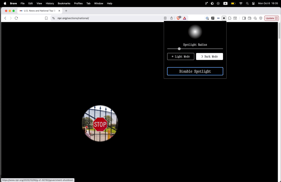 Screenshot image of a webpage filled with black except a circle that reveals the page's contents (a stop sign)