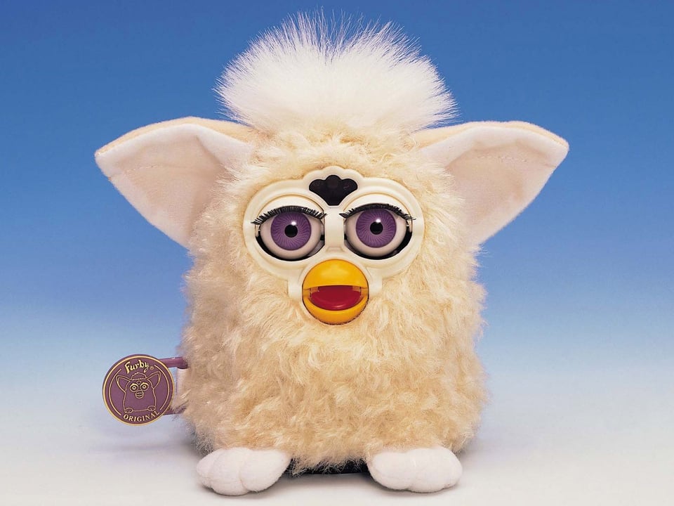 A vintage Furby toy, a little gremlin-like thing with big ears and a furry body