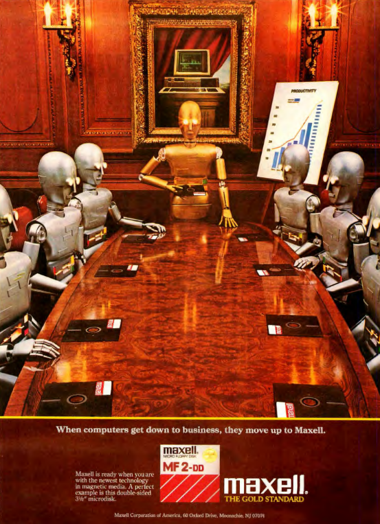 A gold robot stands at the head of a large meeting table surrounded by silver robots. Each robot has a 5.25" floppy disk in front of them. There is a graph with an upward sloping line and a "Productivity" heading. On the wall is a gold-framed painting of an old desktop computer.