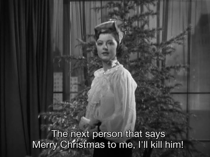 A screenshot from the After the Thin Man, where Myrna Loy is in fron of a christmas tree and the caption says