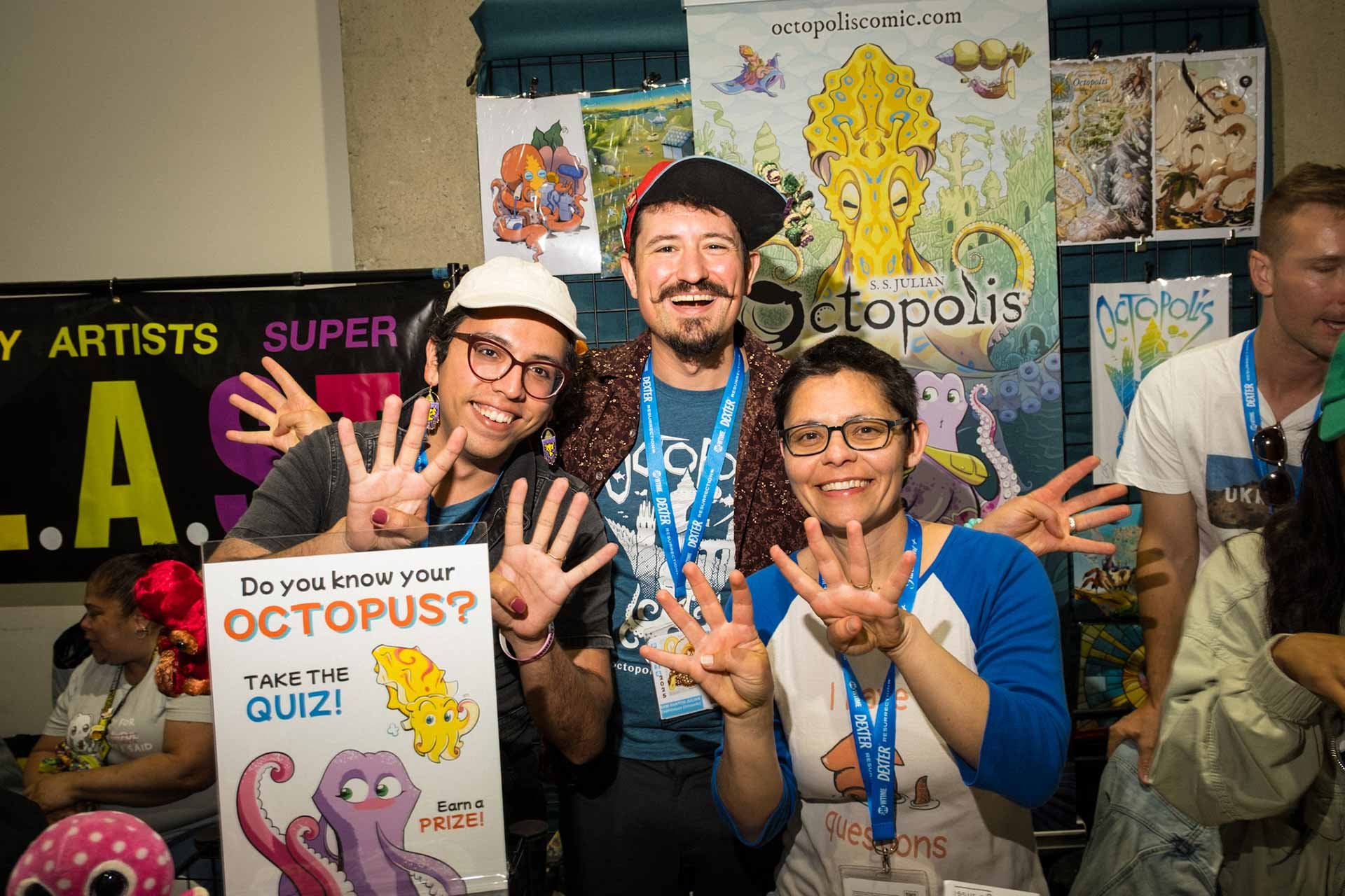 A photograph of myself, Sam, and Danna, our hands holding up 8-fingers.