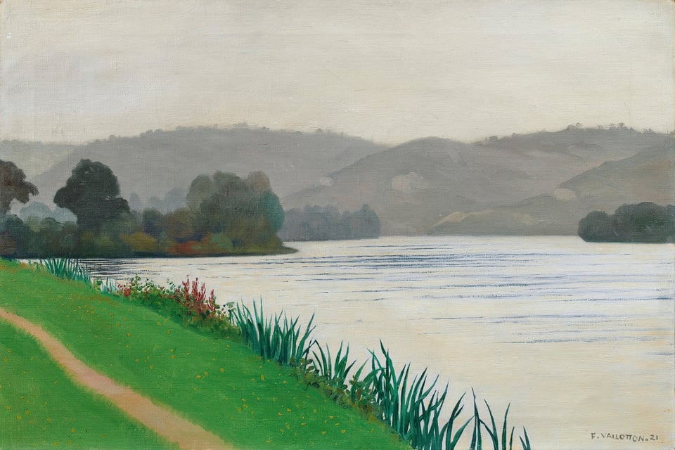 Orange path in green grass along the Seine river