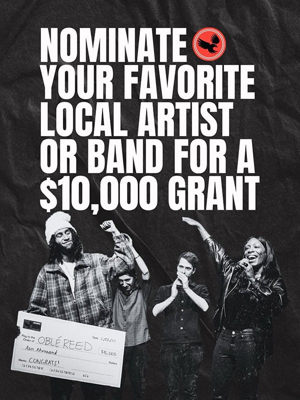 An image of a group of artists cheering and one of them is holding a large $10,000 check