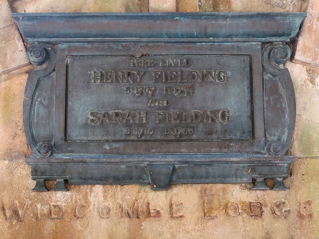 A plaque saying "Here Lived Henry Fielding and Sarah Fielding" set in a pale orange wall