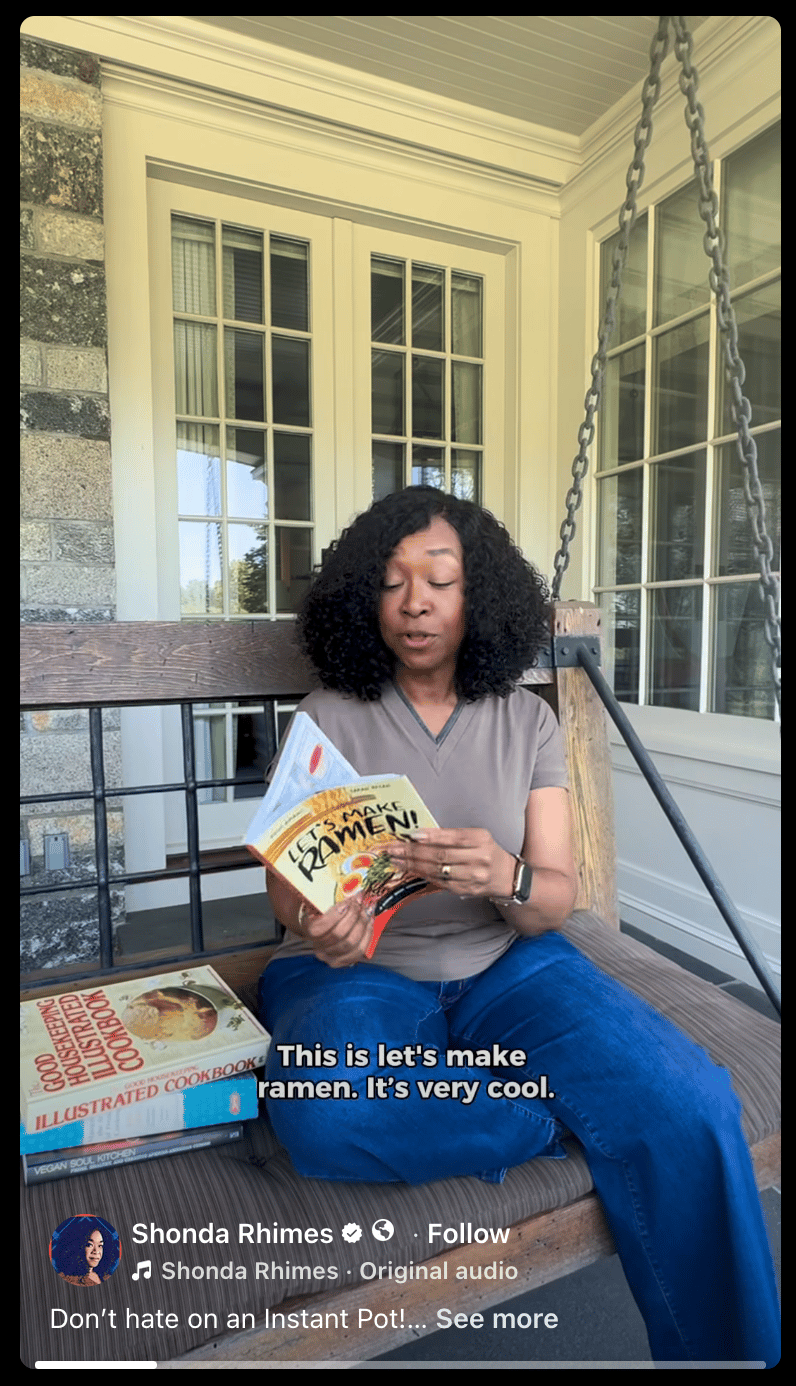 A screencap of Shonda Rhime's reel showing her sitting on a porch, holding Let's Make Ramen, and saying "This is Let's Make Ramen, It's very cool".