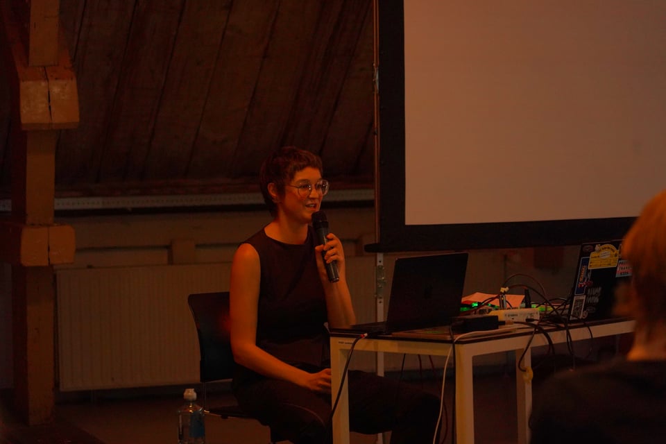 A presenter talking in front of an audience