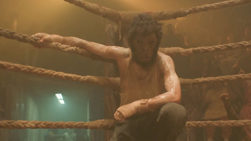 A still from Monkey Man, where the hero is in the ring fighting with his mask on