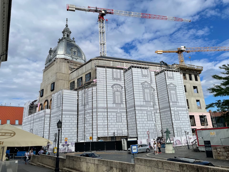 An image of the construction work on Castle Hill in Budapest last summer shows a concrete infrastructure with fancy cartoon-castle imagery on the scaffolding. This is part of the ruling party's effort to make a cartoon tourist trap