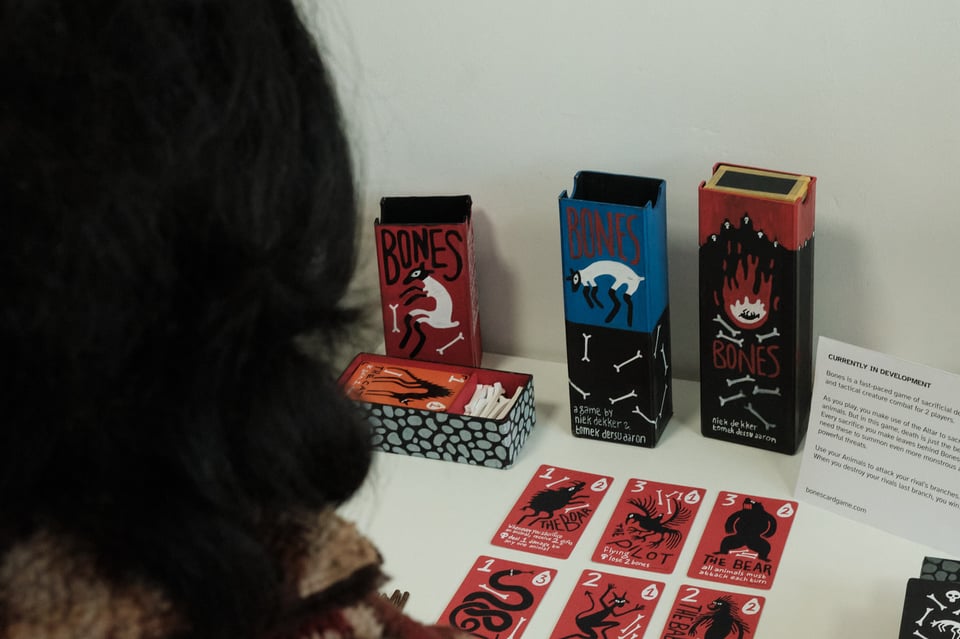 Person looks down at a series of cards marked "Bones"