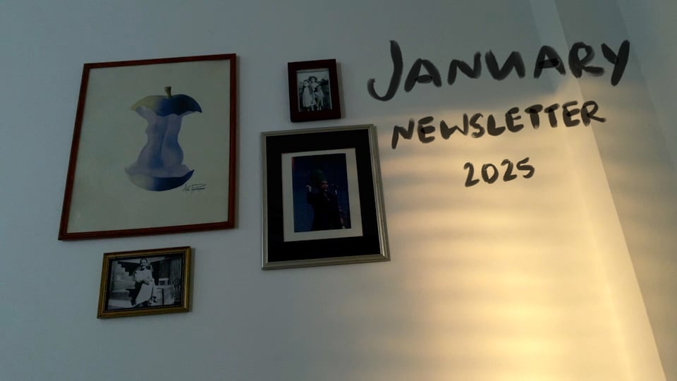 A white wall with photos and artwork, a light pattern, and text "January Newsletter 2025"