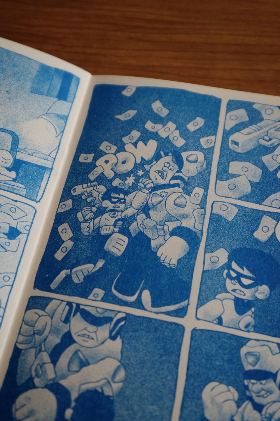 picture of the comic "young shadow: tunnel vision"  the masked kid is punching a cop in the chin as paper currency showers down around them