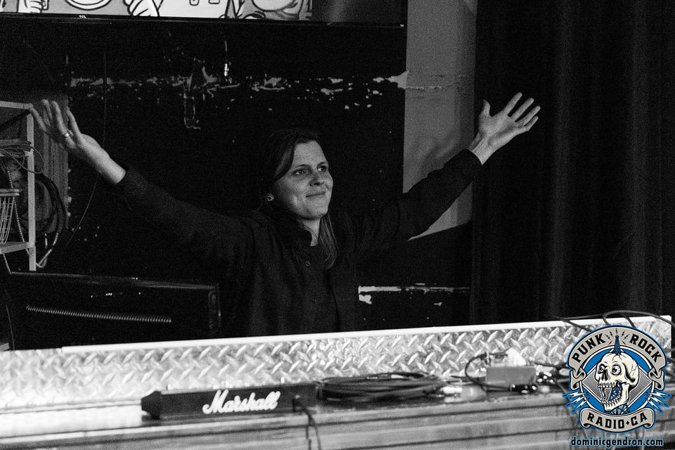 Mika lève les bras, heureuse de vivre le moment présent