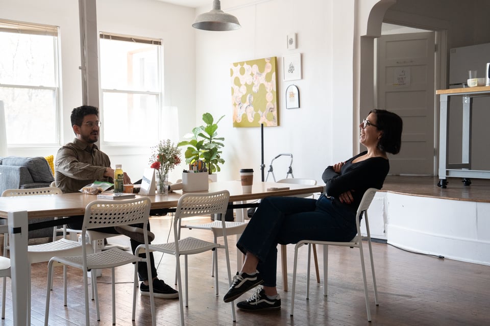 Fewer people eating lunch around a table.