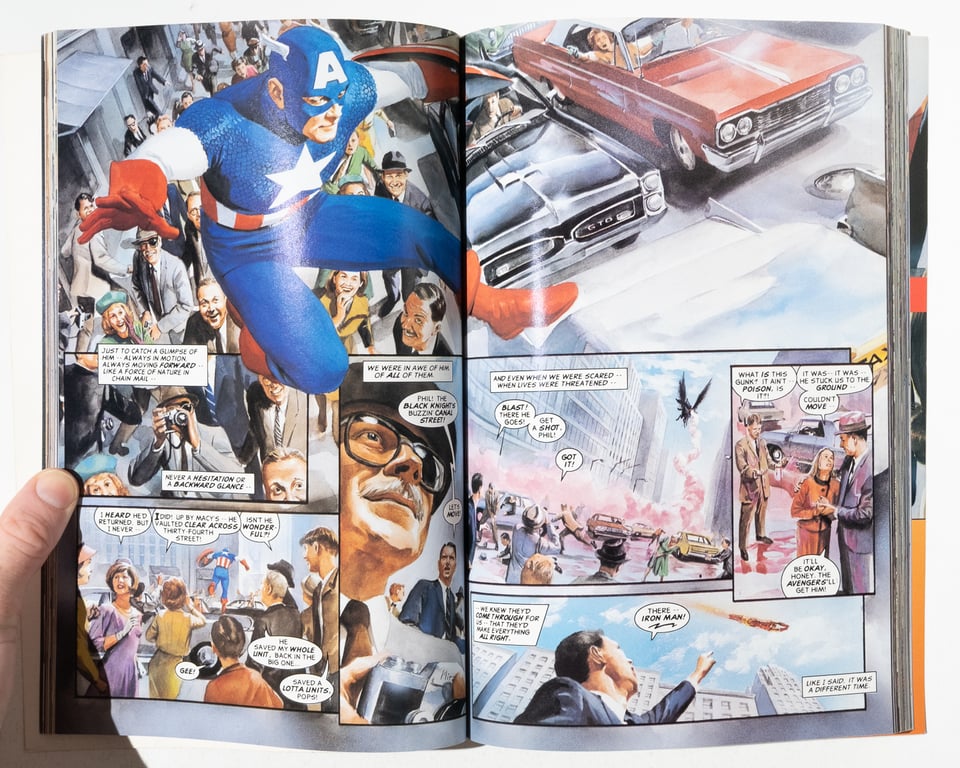 a spread from "Marvels" of Captain America leaping over a crowded street in pursuit of a supervillain