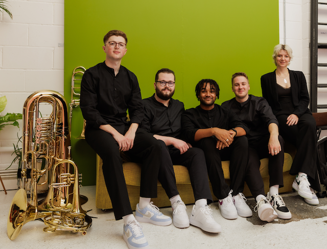 A brass quintet, with their instruments.