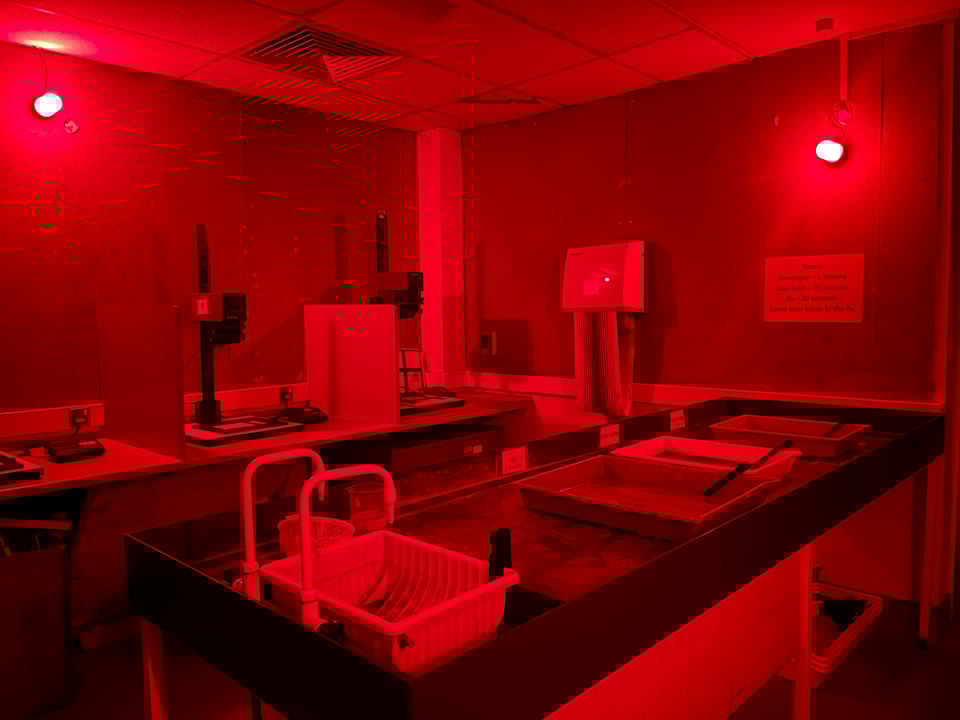 A picture of a photography darkroom with red safelights on