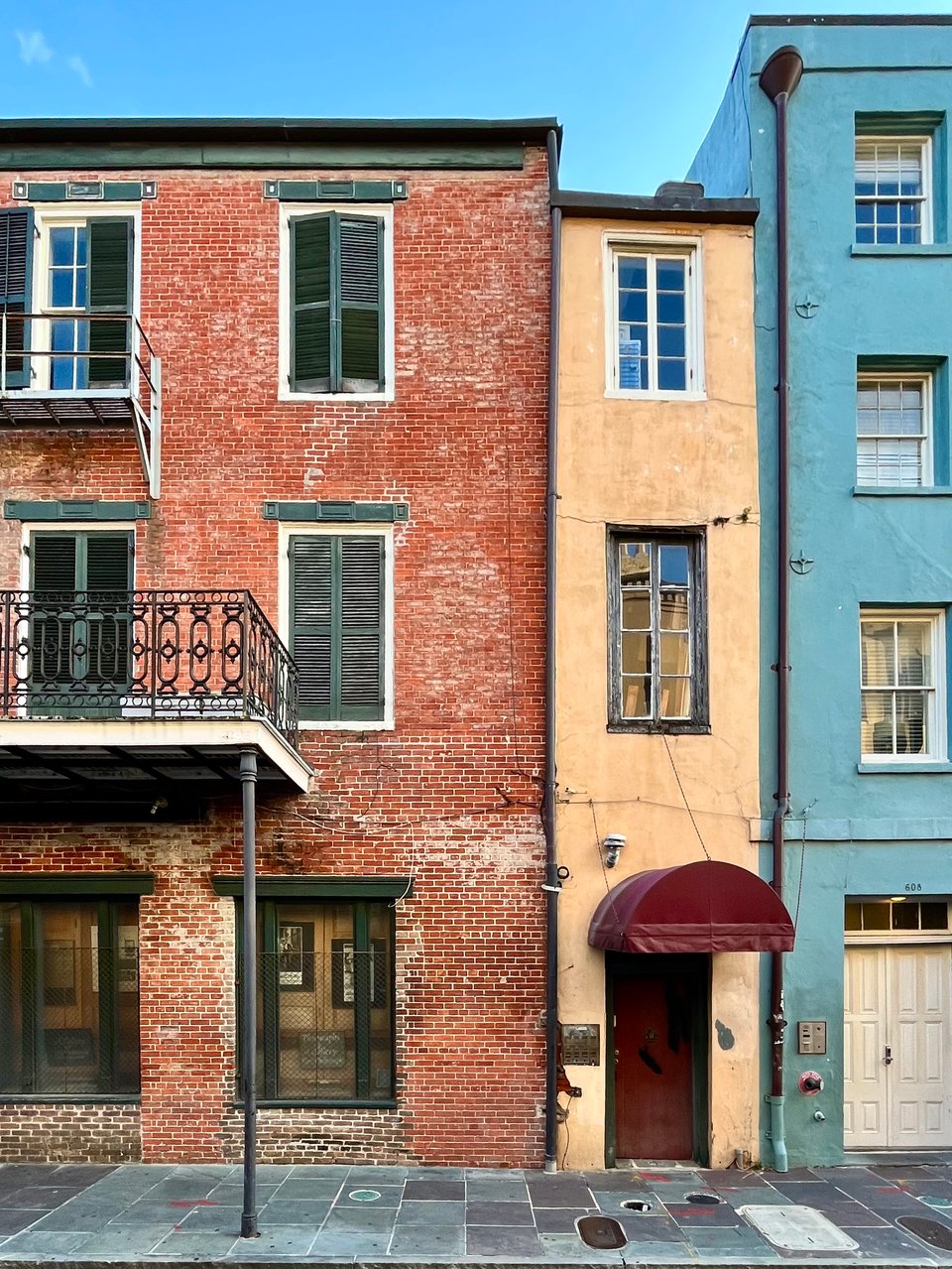 a row of multicolored buildings weathering beautifully in New Orleans