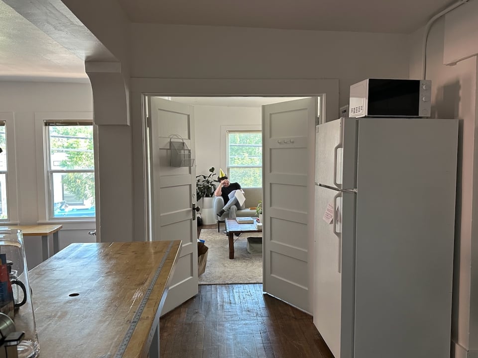 Ivan sits in the conference room laughing