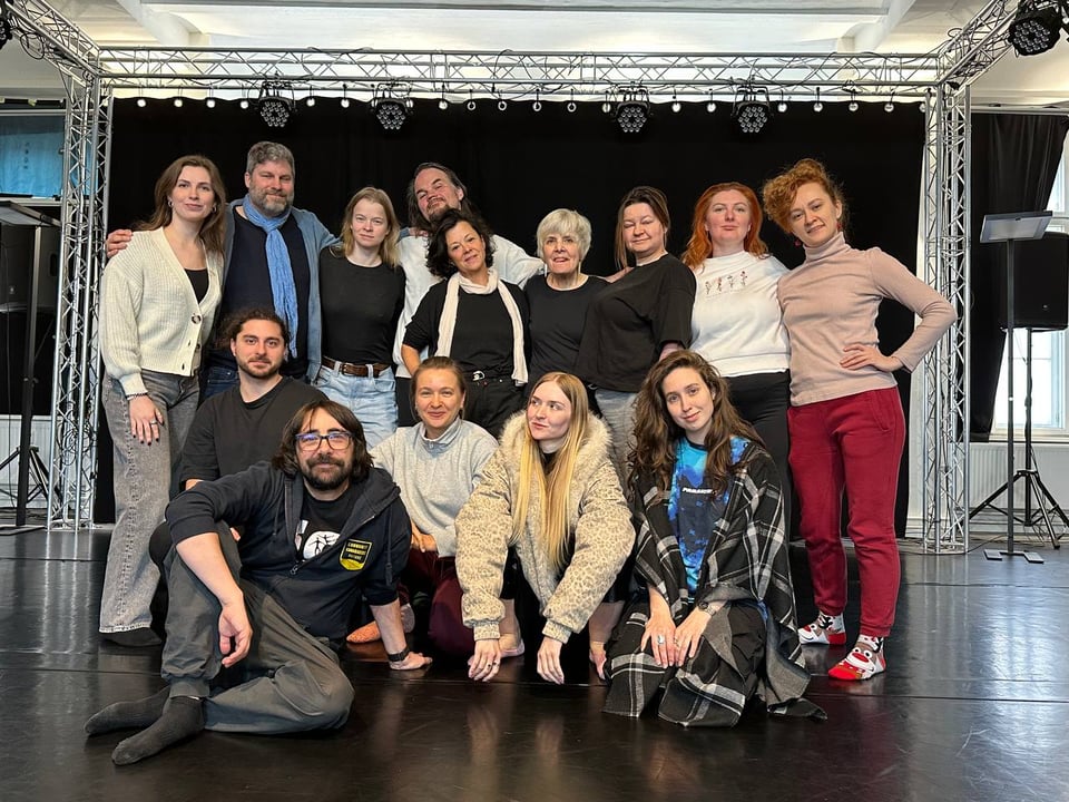 a group of people posing on stage
