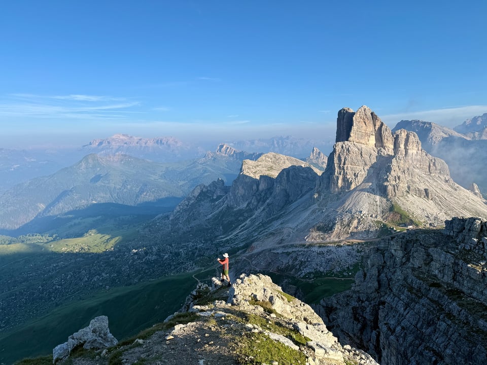 a man taking a picture before a sweeping view