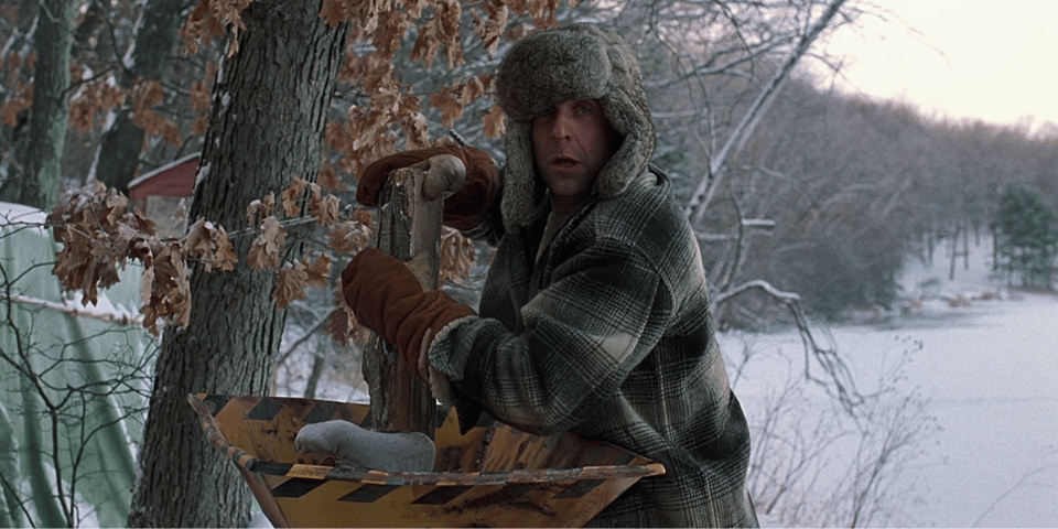 A foot sticks out of a wood chipper.