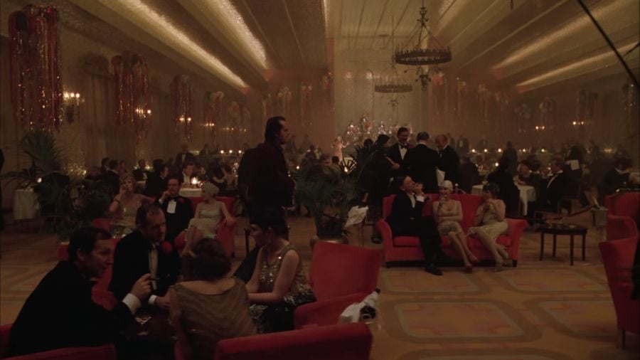 The Overlook Hotel’s ballroom is filled with people - the men wearing black suits and bow ties, the women dressed in dresses in shades of gold and with hair done in the flapper style.