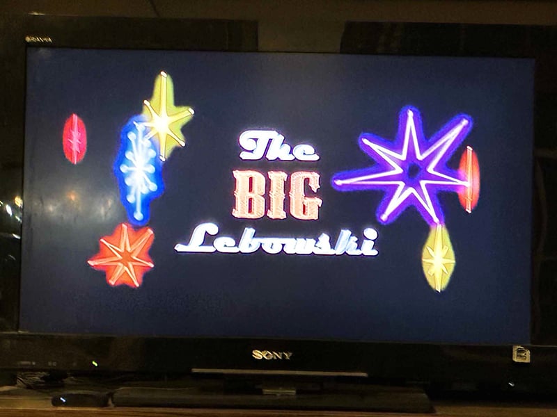 A photo of my television, which in this instant displays the title of the movie The Big Lebowski.