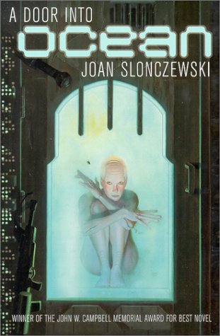 Cover of A Door into Ocean, by Joan Slonczewski, featuring a pale, finger-and-toe-webbed individual with purple undertones and a bald head locked behind a glass door with a black metal frame next to guns and servers, with additional text noting that it is a winner of the John W. Campbell Memorial Award for Best Novel
