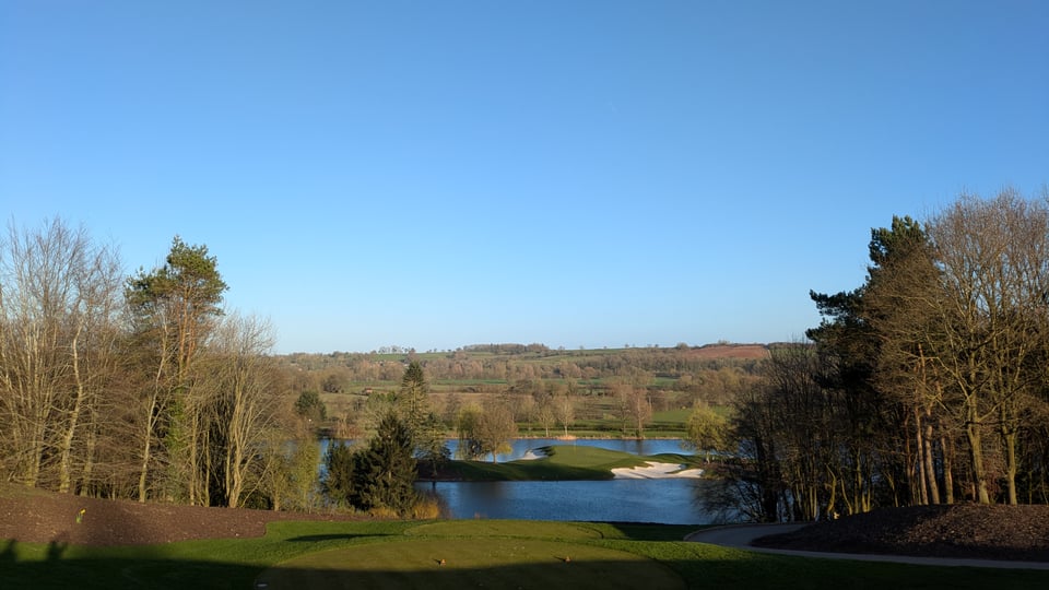 Par 3 17 signature hole, looking down from the tee box with a 190 yard carry off the yellows to an island green
