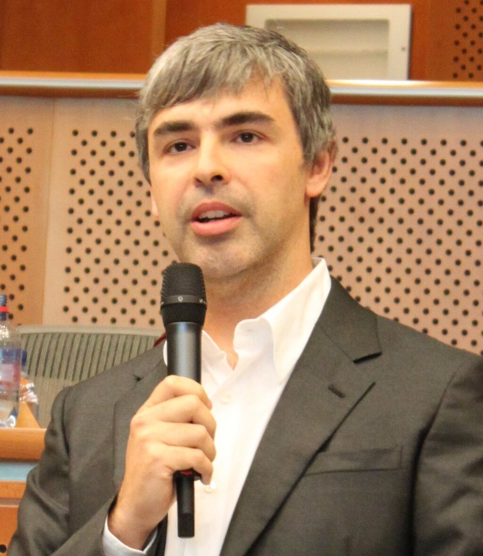Photo of Larry Page speaking into a microphone. Image via https://en.wikipedia.org/wiki/Larry_Page#/media/File:Larry_Page_in_the_European_Parliament,_17.06.2009_(cropped).jpg