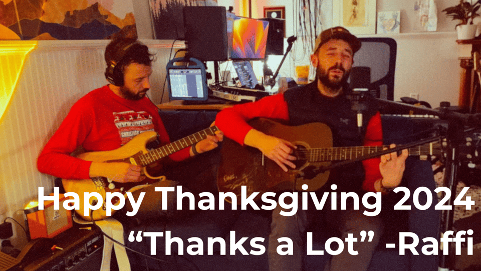 a man sitting on a couch next to himself, both playing guitar