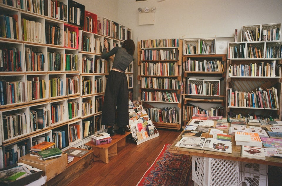 [Chaski arranging books on the library shelves, or perhaps looking for a particular one.]