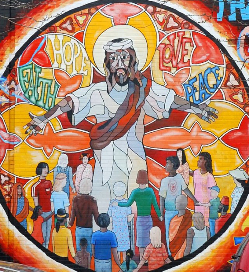 mural in bright colors showing robed Jesus with many skin colors, surrounded by people of different races, ages, and genders, and the words "faith," "hope," "love," and "peace."
