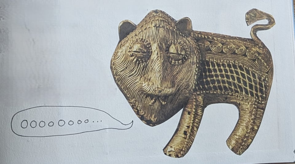 a cut out gold tiger saying "oooooooo..."