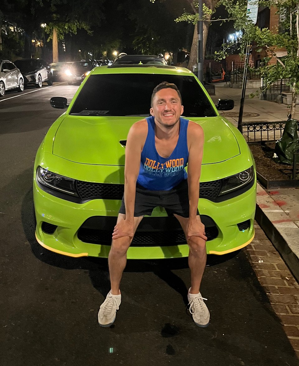 The author in front of a lime-green car.